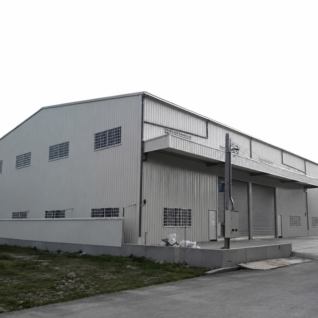 Steel structure warehouse building with metal wall panels, ventilation openings, and roller shutter doors