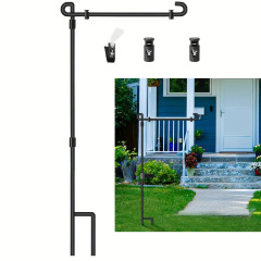 Black iron garden flag stand installed in a front yard on soft ground