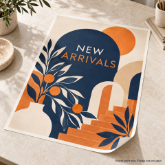 Mockup of an unframed custom paper poster with navy and orange new arrivals artwork on a tabletop
