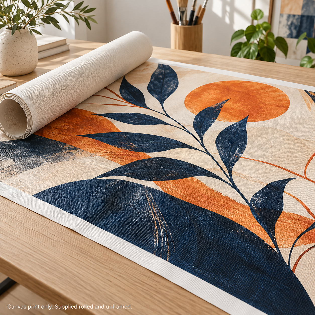 Mockup of a partially unrolled custom canvas print with navy and orange botanical artwork on a tabletop