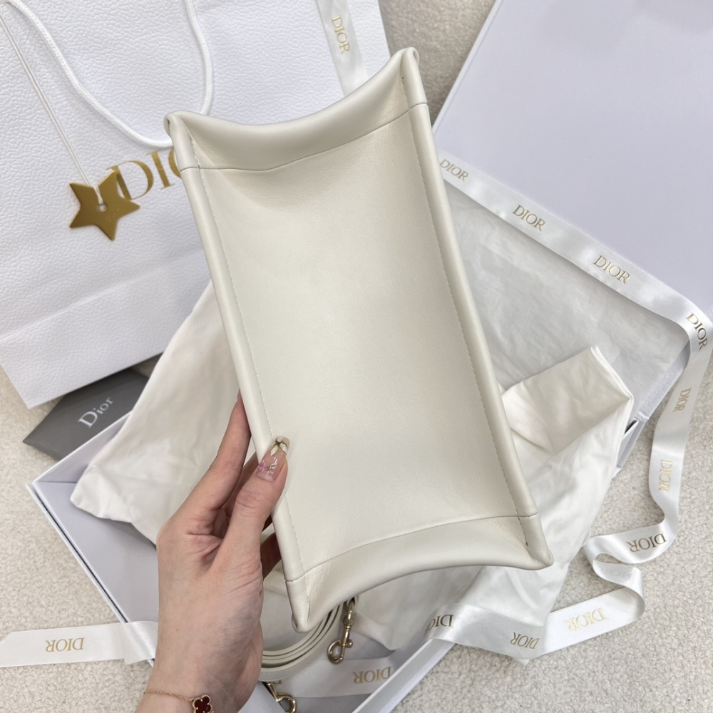 The medium-sized Dior Book Tote in quilted, also known as the "Dior quilted tote bag," is a leather upgrade of the classic Book Tote.