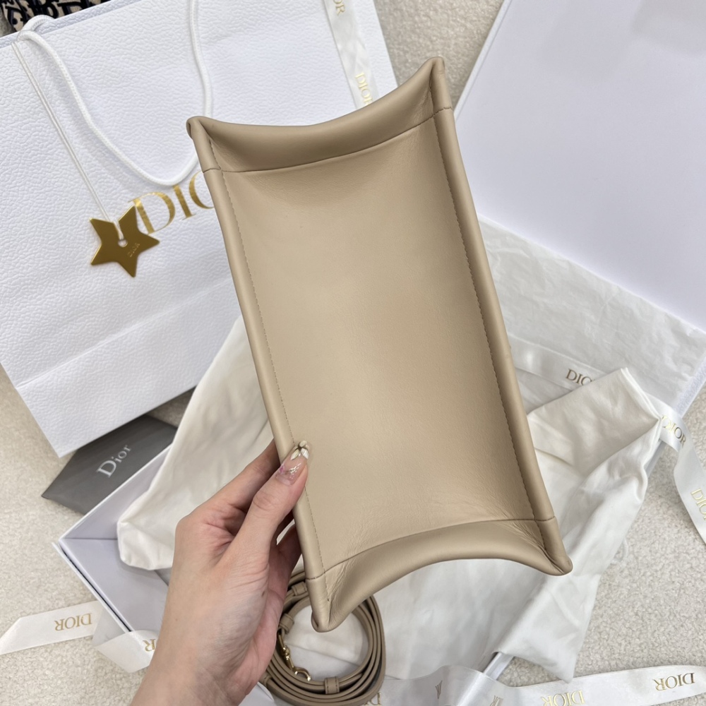 The medium-sized Dior Book Tote in quilted, also known as the "Dior quilted tote bag," is a leather upgrade of the classic Book Tote.