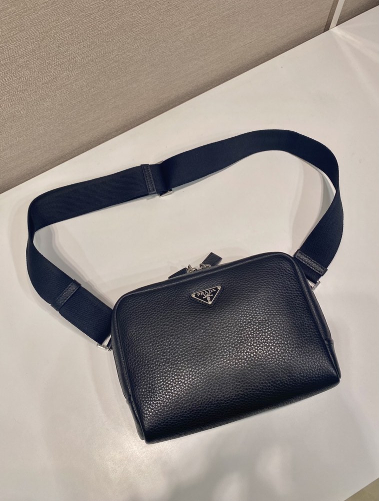 Prada's classic pebbled leather camera bag is the brand's signature unisex crossbody bag.