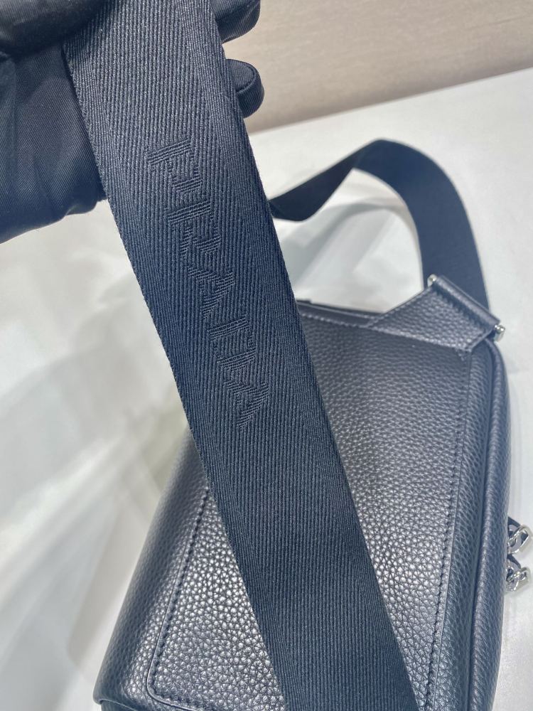 Prada's classic pebbled leather camera bag is the brand's signature unisex crossbody bag.