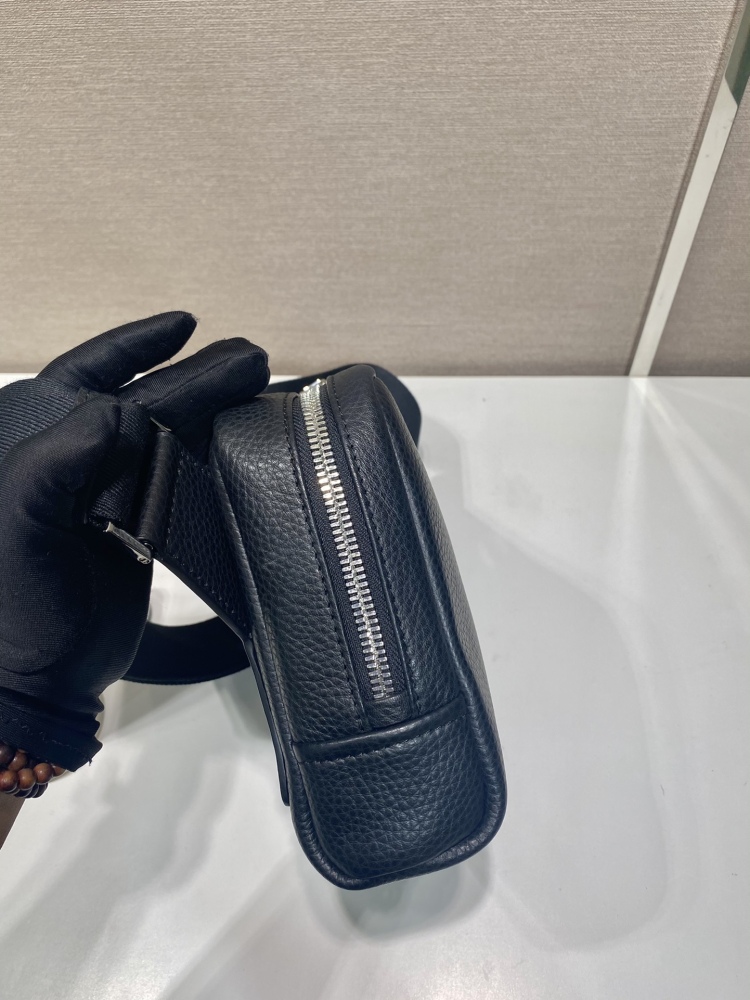 Prada's classic pebbled leather camera bag is the brand's signature unisex crossbody bag.