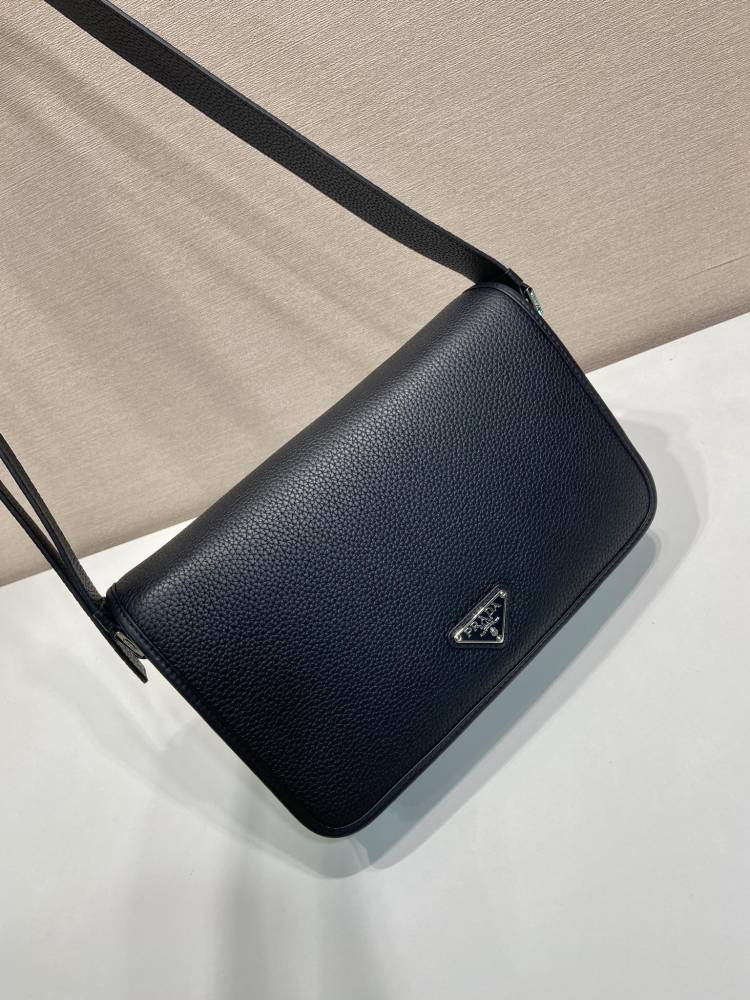 Prada's classic pebbled leather messenger camera bag is the brand's signature unisex crossbody bag.