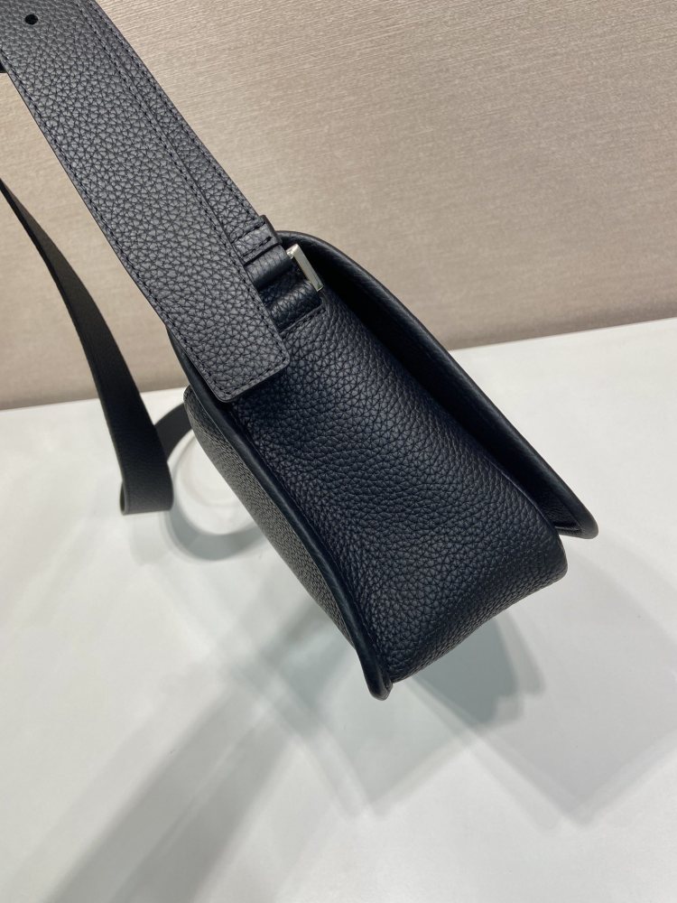 Prada's classic pebbled leather messenger camera bag is the brand's signature unisex crossbody bag.