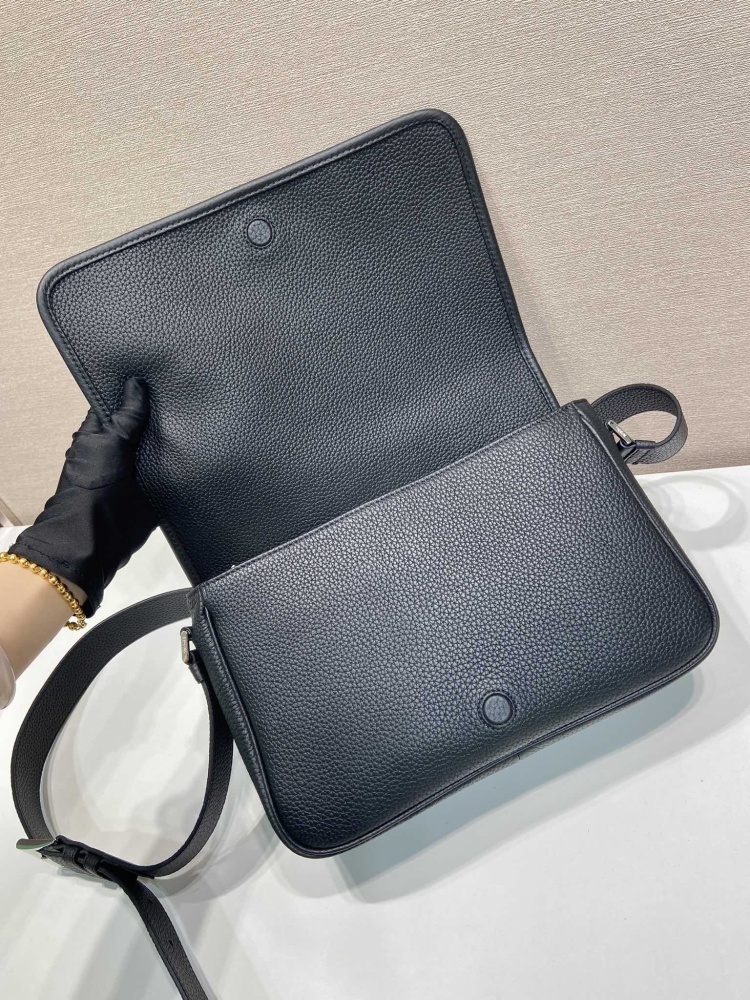 Prada's classic pebbled leather messenger camera bag is the brand's signature unisex crossbody bag.