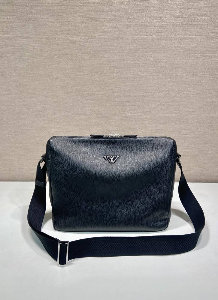 Prada's large messenger camera bag in pebbled calfskin is a signature unisex, spacious commuter style.