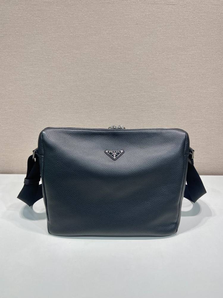 Prada's large messenger camera bag in pebbled calfskin is a signature unisex, spacious commuter style.