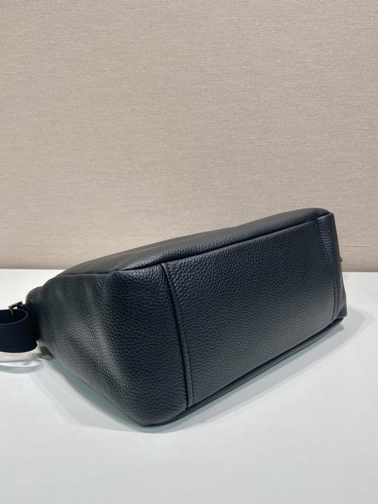 Prada's large messenger camera bag in pebbled calfskin is a signature unisex, spacious commuter style.