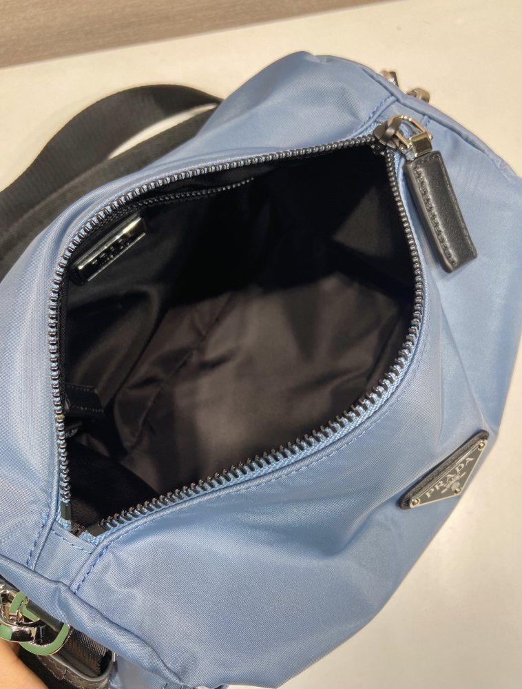 The Prada Re-Nylon double-strap commuter bag is one of the representative styles of Prada's classic utilitarian aesthetic.