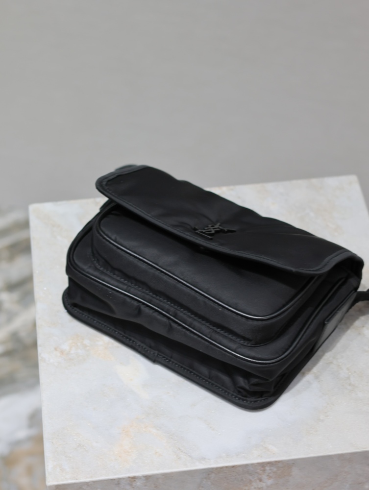 The YSL Saint Laurent Niki small nylon messenger bag is one of the brand's iconic "dark style" favorites.