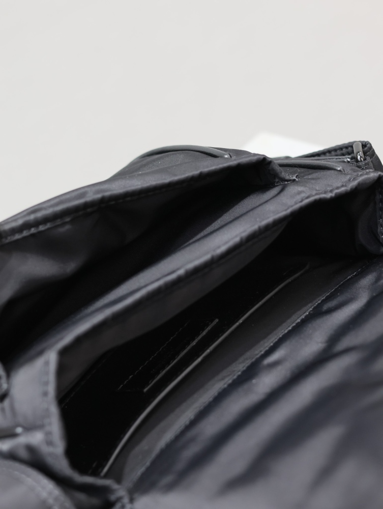 The YSL Saint Laurent Niki small nylon messenger bag is one of the brand's iconic "dark style" favorites.