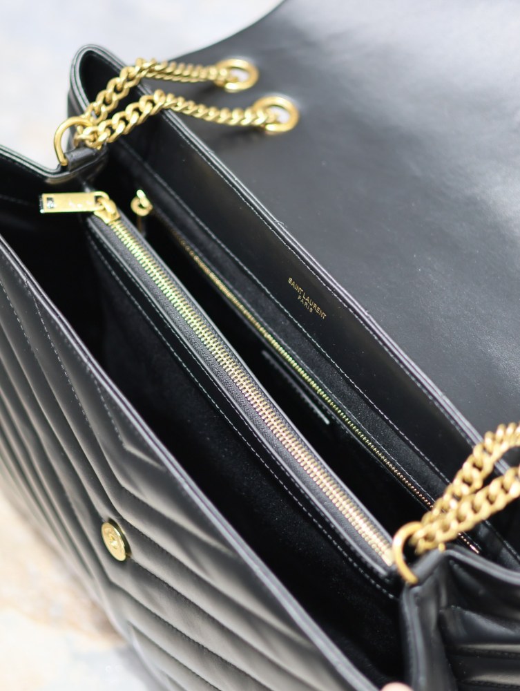 The YSL Saint Laurent LouLou large quilted tote bag, also known as the "envelope tote," is a signature and popular commuter style from the brand.