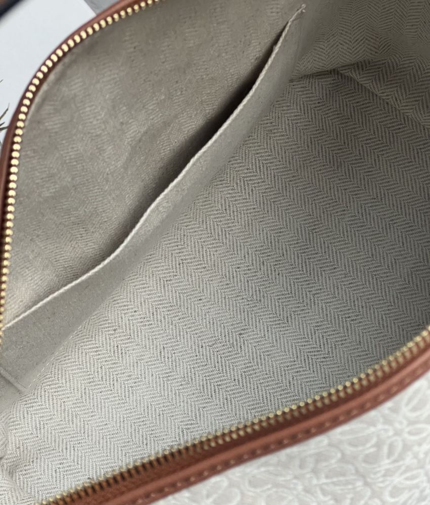 The LOEWE Cubi Small Anagram Jacquard Canvas Shoulder Bag—colloquially known as the "Lunchbox Bag"—is one of LOEWE's hottest and most sought-after styles in recent years.