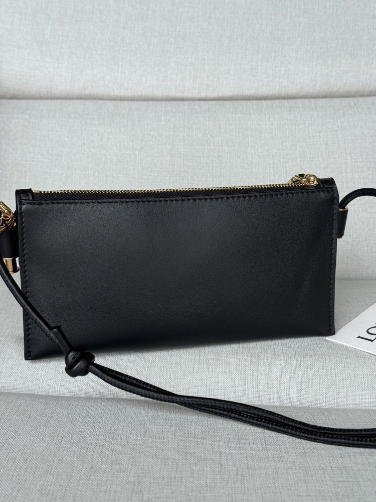 The LOEWE Joya clutch—crafted from Nappa calfskin and also wearable as a small crossbody bag—is a practical piece that embodies the brand's minimalist aesthetic.