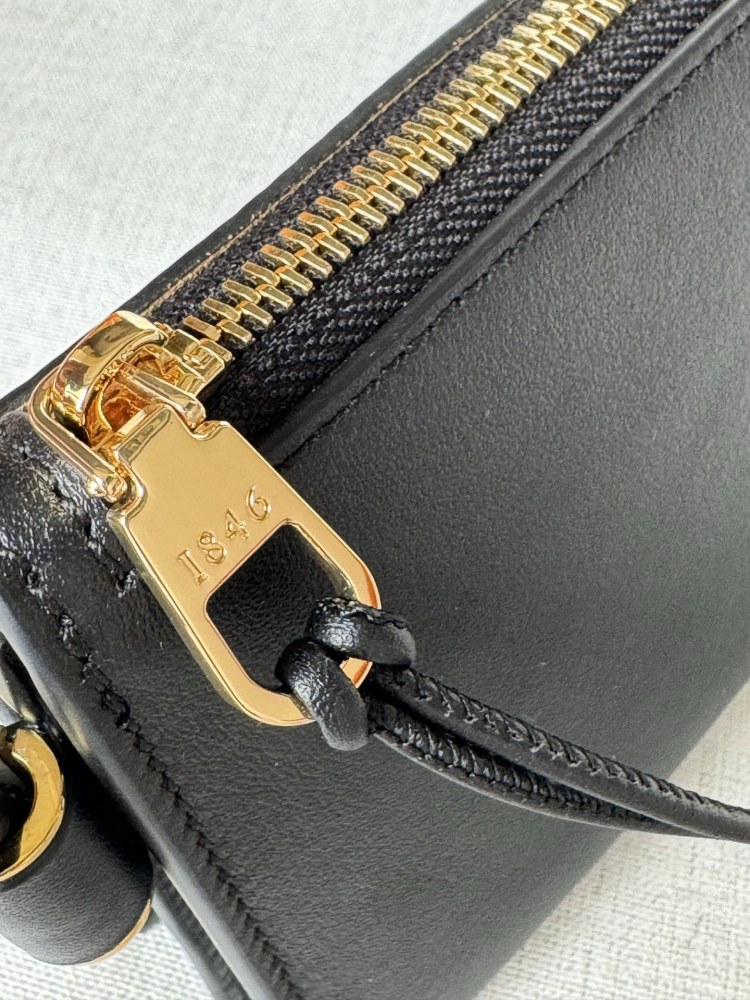 The LOEWE Joya clutch—crafted from Nappa calfskin and also wearable as a small crossbody bag—is a practical piece that embodies the brand's minimalist aesthetic.