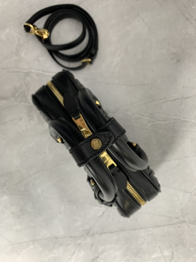 The Miu Miu Matelassé mini bowling bag (black) is a highly popular and trending item from the brand in recent years.