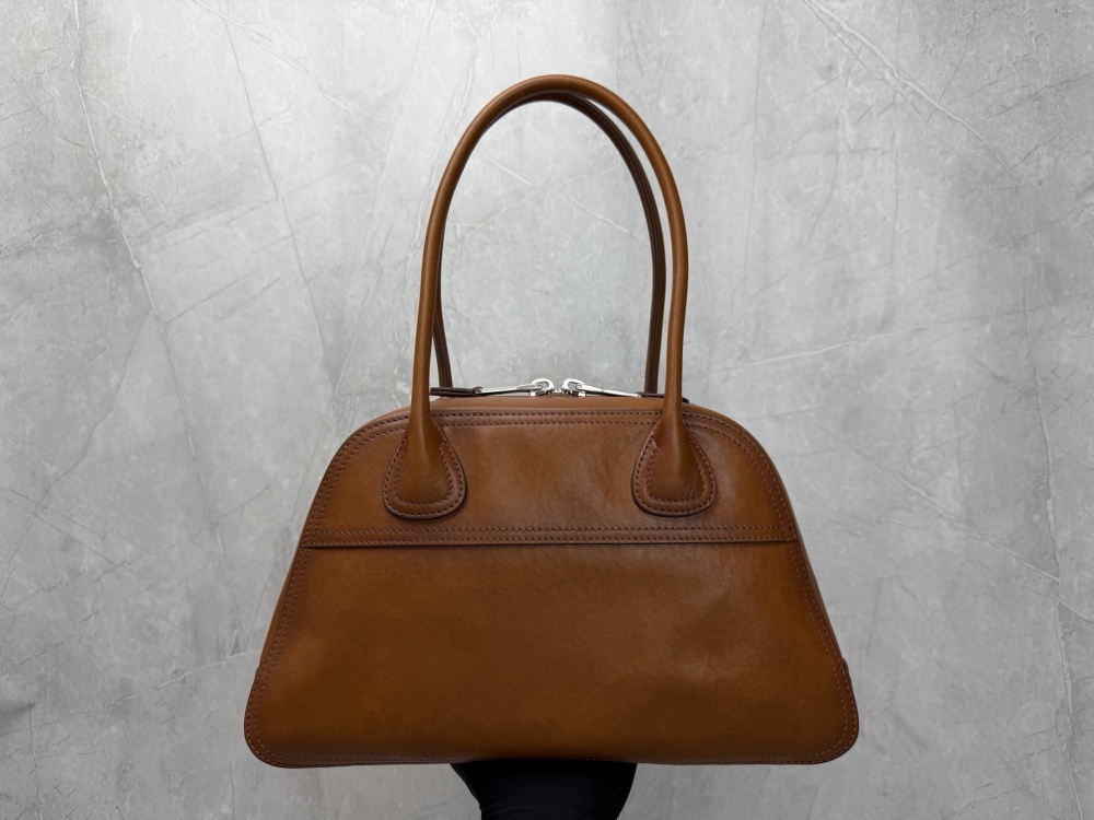 The Miu Miu vintage bowling tote bag is a popular vintage-style work bag in recent years.