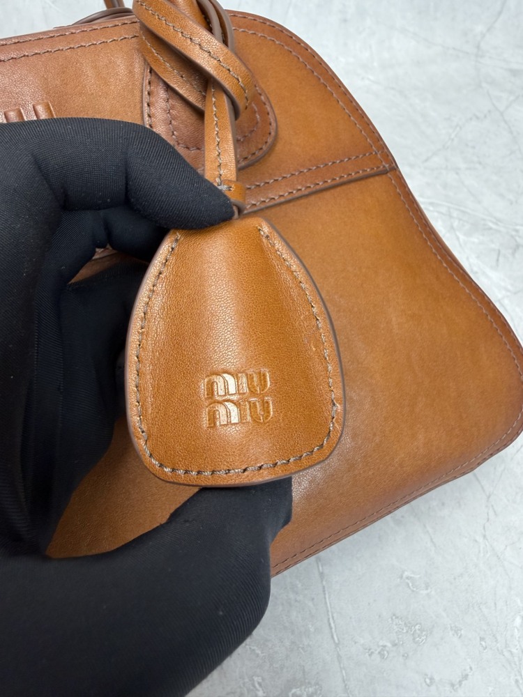 The Miu Miu vintage bowling tote bag is a popular vintage-style work bag in recent years.