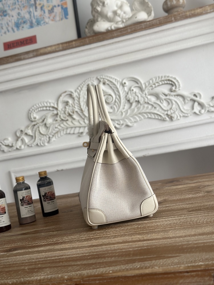 The classic Hermès Birkin bag, specifically the Birkin 25 canvas and leather version, is a popular Hermès "patchwork/canvas and leather" version.