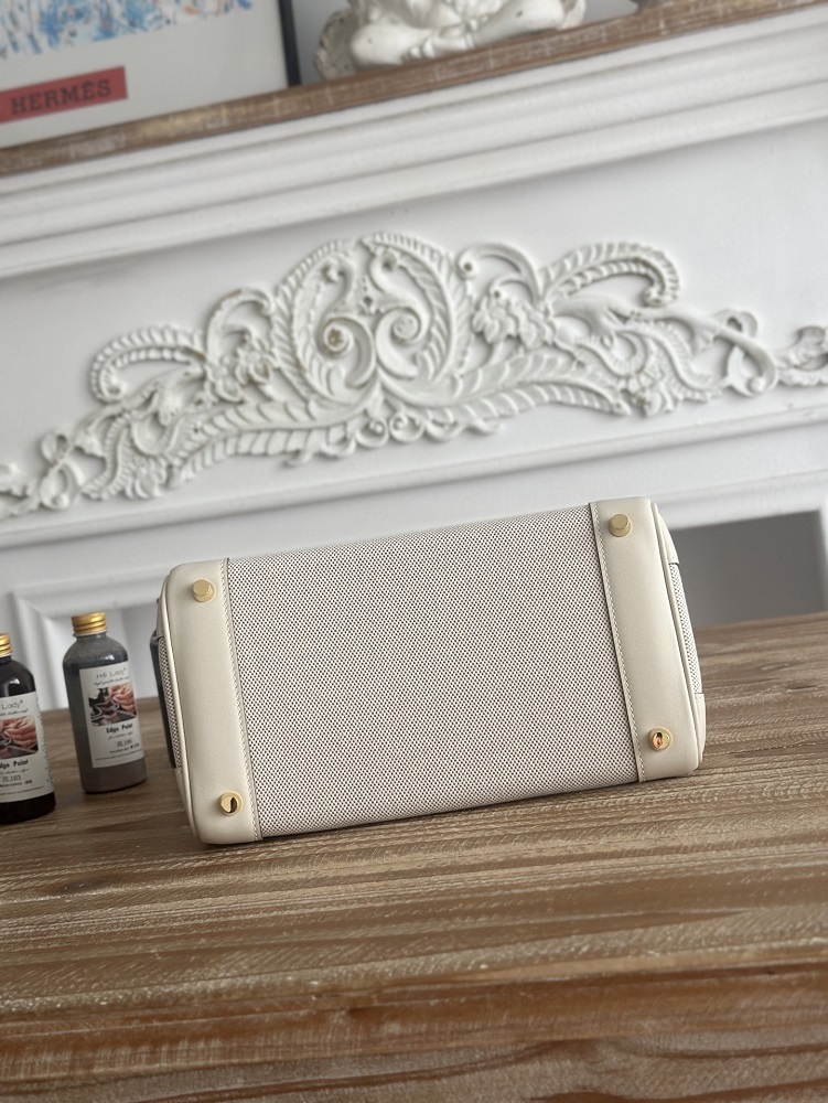 The classic Hermès Birkin bag, specifically the Birkin 25 canvas and leather version, is a popular Hermès "patchwork/canvas and leather" version.