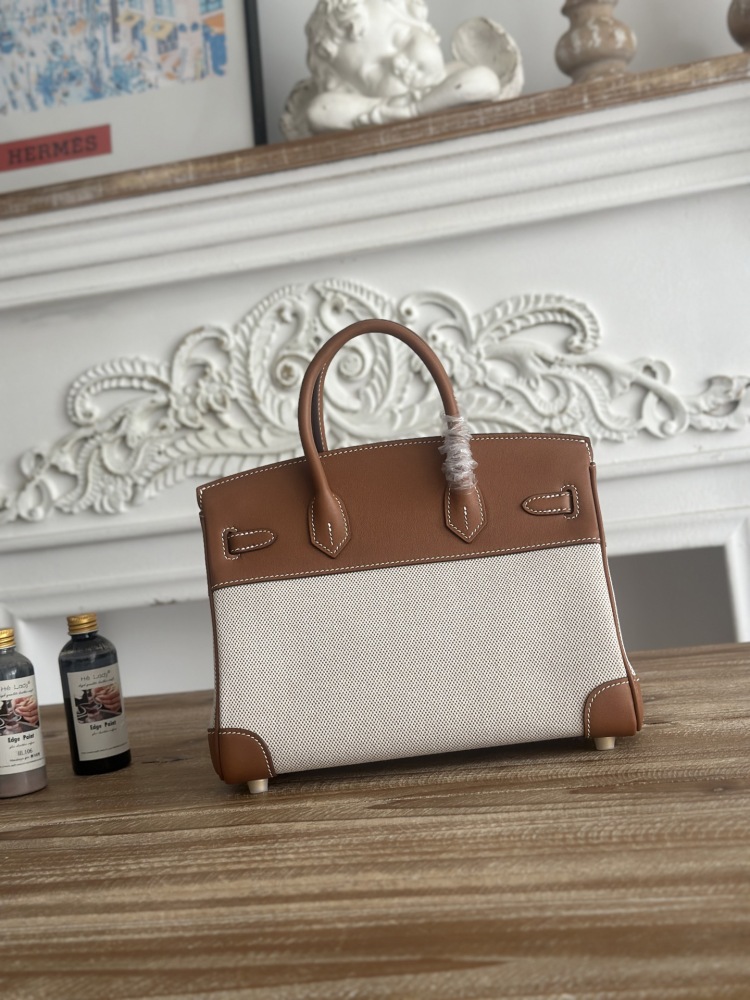 A Birkin-style bag in gold-brown leather and canvas, with an overall retro and versatile style.