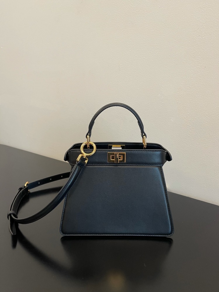 The Fendi Peekaboo mini handbag (navy/black) is the brand's iconic "little monster" bag.