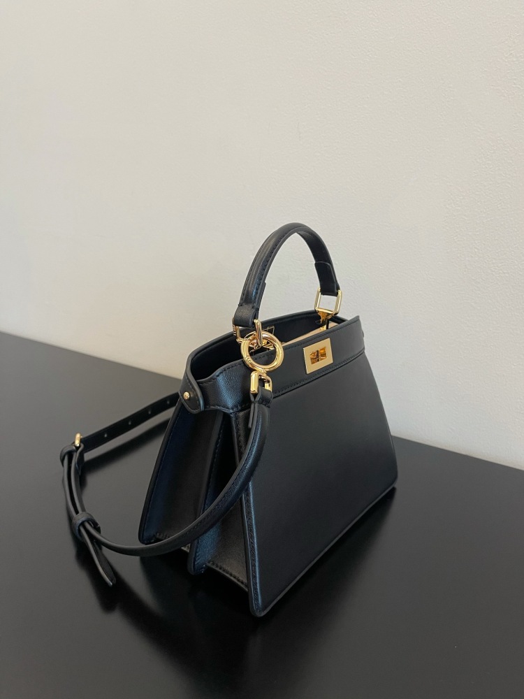 The Fendi Peekaboo mini handbag (navy/black) is the brand's iconic "little monster" bag.