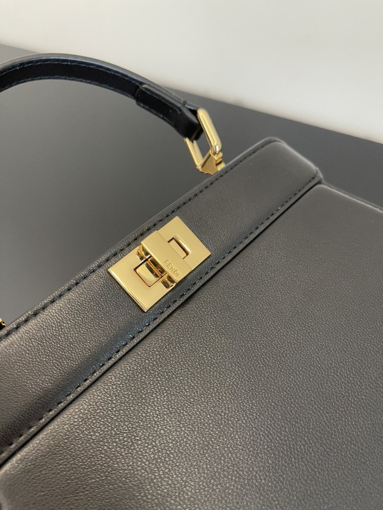The Fendi Peekaboo mini handbag (navy/black) is the brand's iconic "little monster" bag.