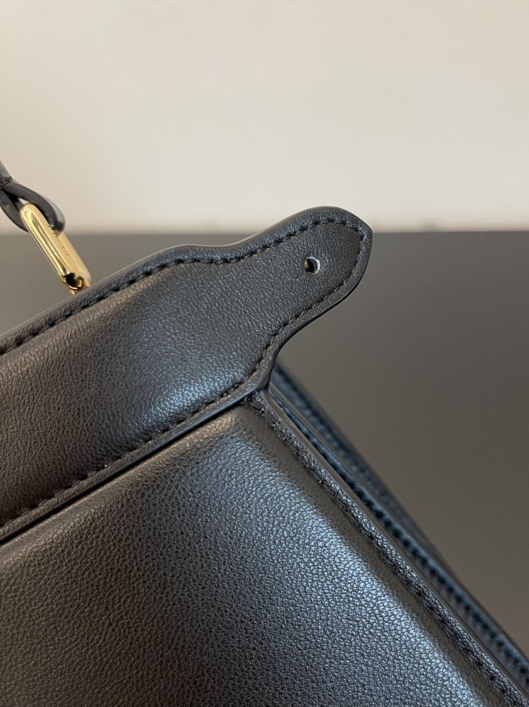 The Fendi Peekaboo mini handbag (navy/black) is the brand's iconic "little monster" bag.