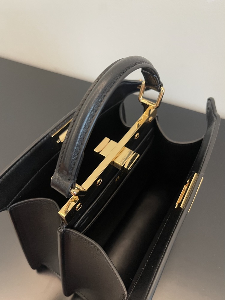The Fendi Peekaboo mini handbag (navy/black) is the brand's iconic "little monster" bag.