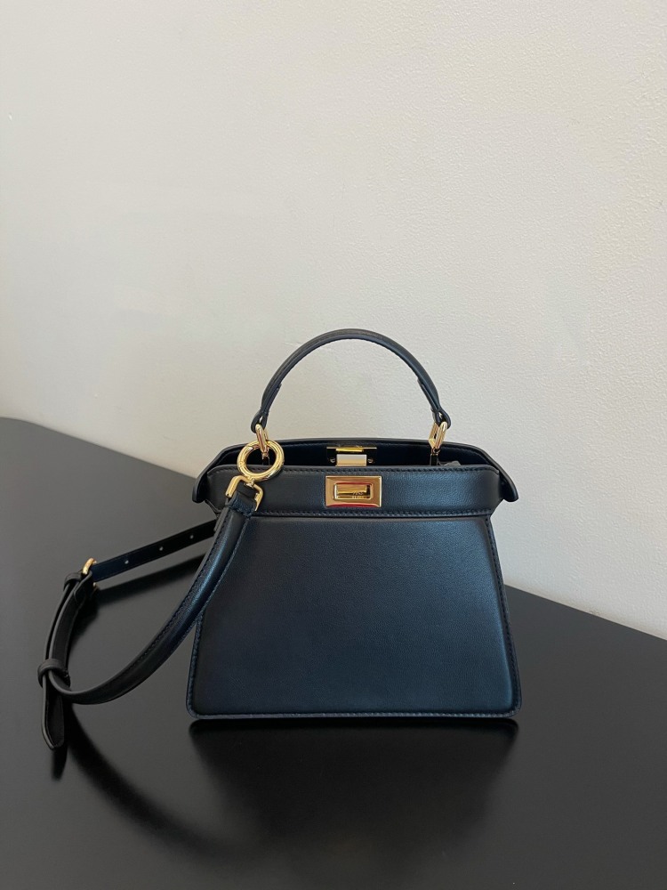 The Fendi Peekaboo mini handbag (navy/black) is the brand's iconic "little monster" bag.