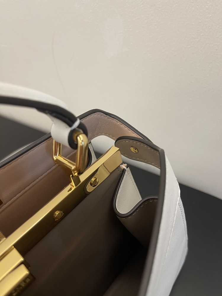 The Fendi Peekaboo mini handbag (off-white) is the brand's iconic "little monster" bag.