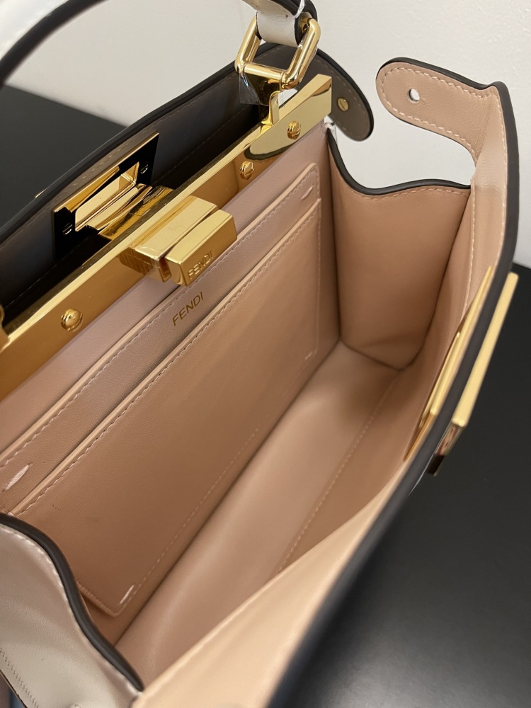 The Fendi Peekaboo mini handbag (off-white) is the brand's iconic "little monster" bag.