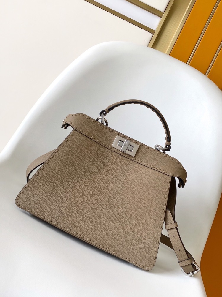 The Fendi Peekaboo medium handbag (in elephant grey/truffle grey Roman stitching) is a premium version of the brand's iconic "little monster" bag.