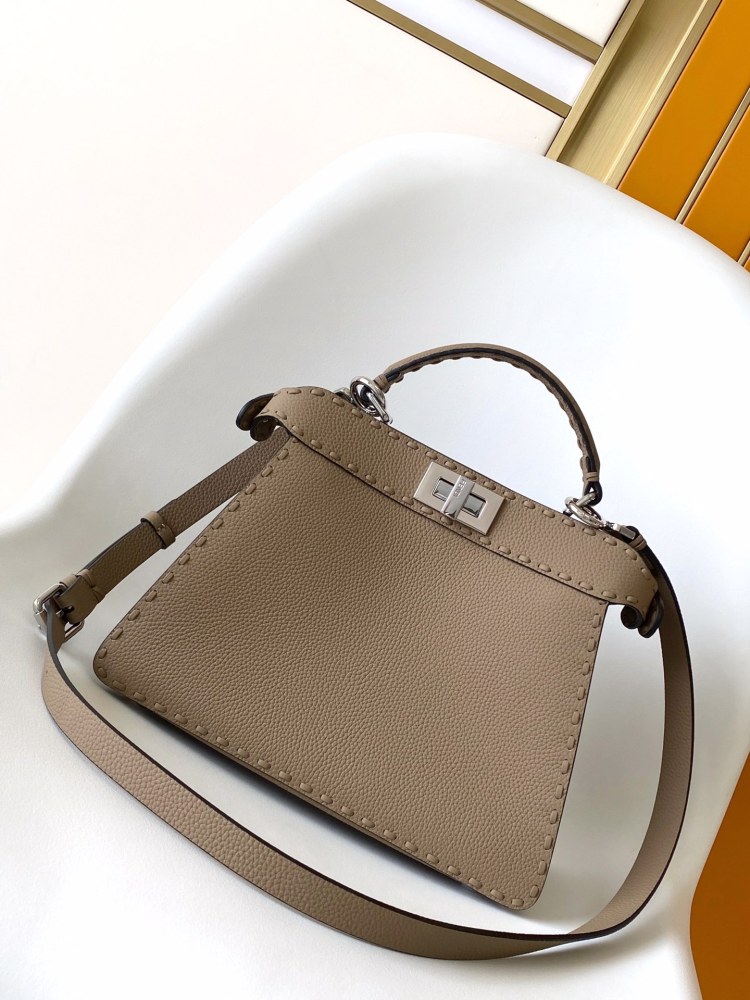 The Fendi Peekaboo medium handbag (in elephant grey/truffle grey Roman stitching) is a premium version of the brand's iconic "little monster" bag.