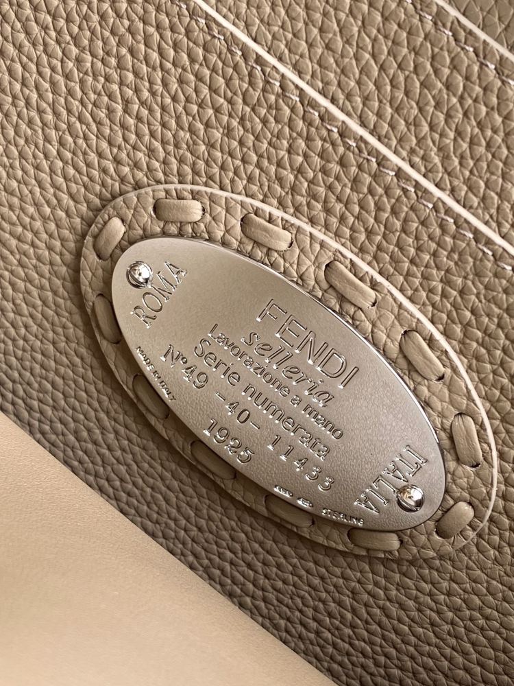 The Fendi Peekaboo medium handbag (in elephant grey/truffle grey Roman stitching) is a premium version of the brand's iconic "little monster" bag.