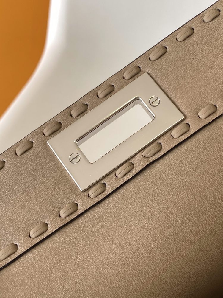 The Fendi Peekaboo medium handbag (in elephant grey/truffle grey Roman stitching) is a premium version of the brand's iconic "little monster" bag.