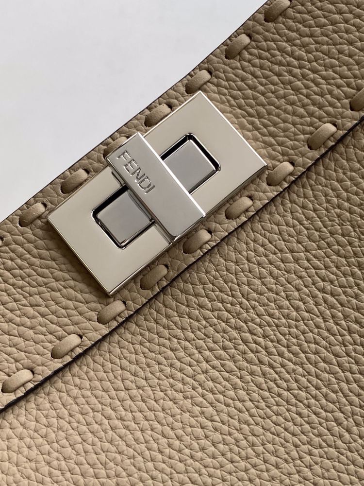 The Fendi Peekaboo medium handbag (in elephant grey/truffle grey Roman stitching) is a premium version of the brand's iconic "little monster" bag.