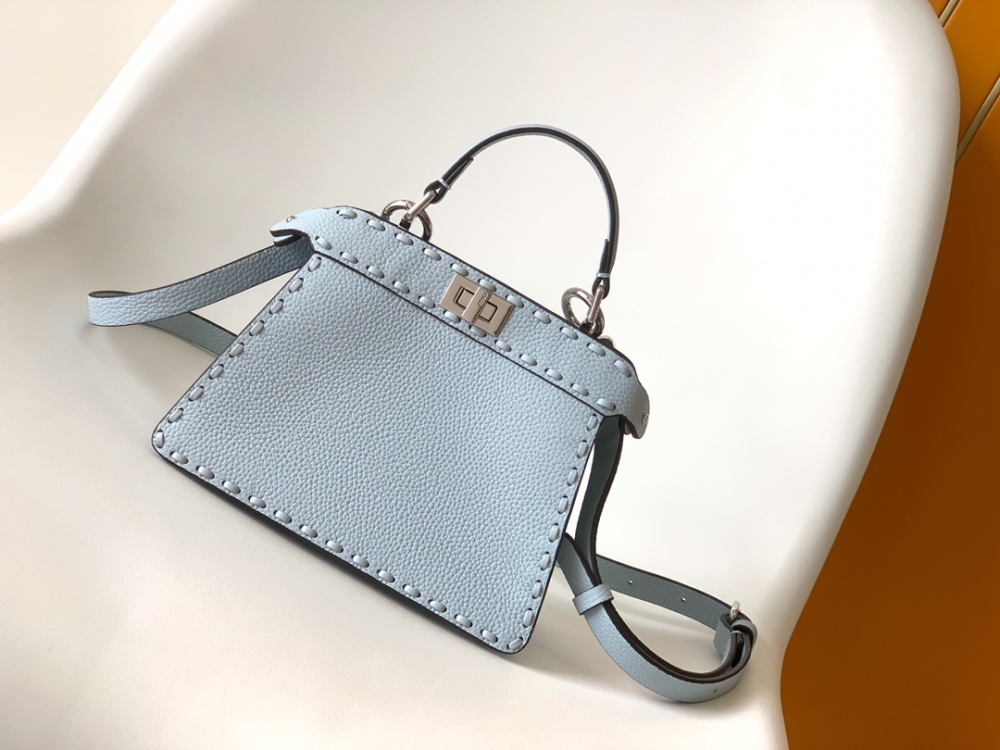 The Fendi Peekaboo mini handbag (ice blue with Roman stitching) is a high-end handcrafted version of the brand's iconic "little monster" bag.