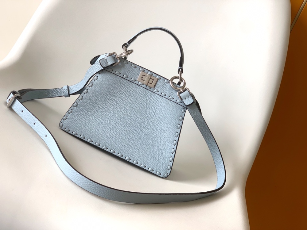 The Fendi Peekaboo mini handbag (ice blue with Roman stitching) is a high-end handcrafted version of the brand's iconic "little monster" bag.