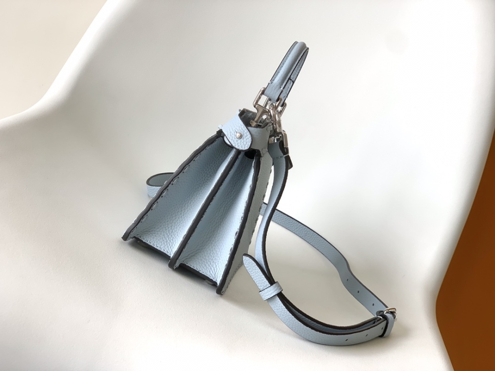 The Fendi Peekaboo mini handbag (ice blue with Roman stitching) is a high-end handcrafted version of the brand's iconic "little monster" bag.