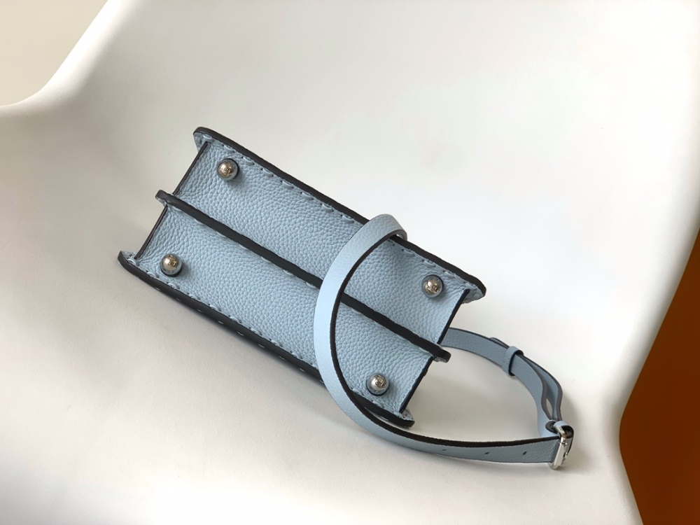 The Fendi Peekaboo mini handbag (ice blue with Roman stitching) is a high-end handcrafted version of the brand's iconic "little monster" bag.