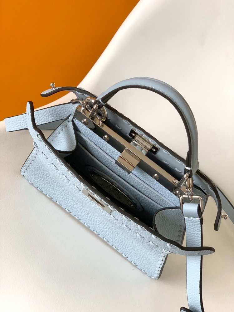 The Fendi Peekaboo mini handbag (ice blue with Roman stitching) is a high-end handcrafted version of the brand's iconic "little monster" bag.