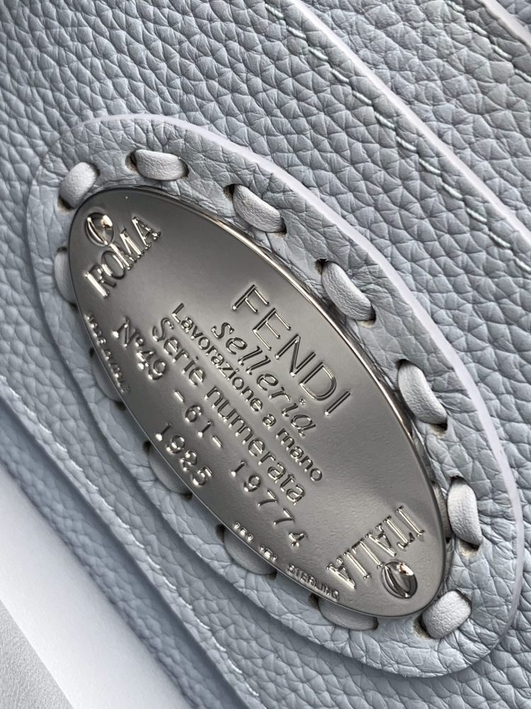 The Fendi Peekaboo mini handbag (ice blue with Roman stitching) is a high-end handcrafted version of the brand's iconic "little monster" bag.