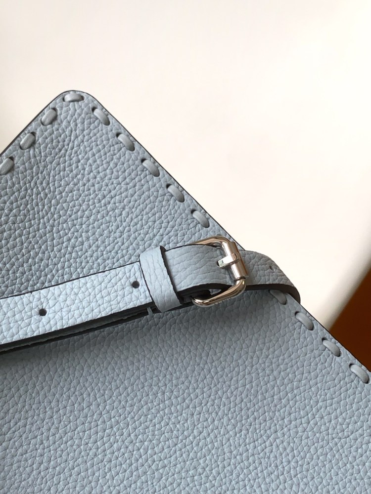 The Fendi Peekaboo mini handbag (ice blue with Roman stitching) is a high-end handcrafted version of the brand's iconic "little monster" bag.