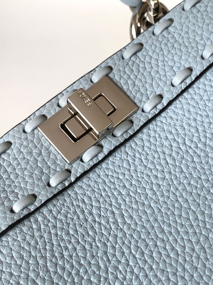 The Fendi Peekaboo mini handbag (ice blue with Roman stitching) is a high-end handcrafted version of the brand's iconic "little monster" bag.