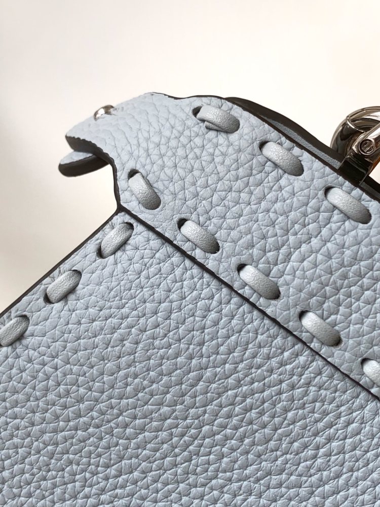 The Fendi Peekaboo mini handbag (ice blue with Roman stitching) is a high-end handcrafted version of the brand's iconic "little monster" bag.